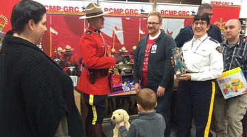 Mounties and Keian's family receiving toys