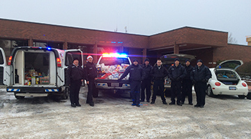 RCMP members with cruisers crammed with donation
