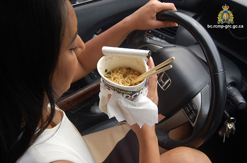 Female eating noodles while driving
