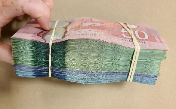 <q>Photo of bundle of seized cash</q>
